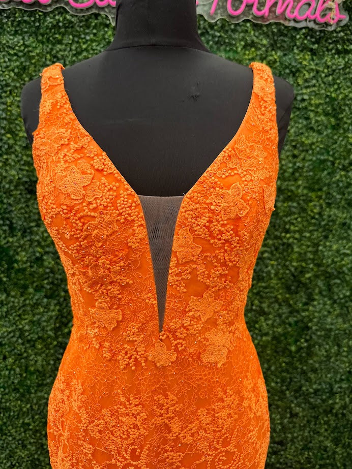 Look stunning in this Johnathan Kayne 31575 Size 4 Orange Lace V Neck Fitted Formal Prom Dress. Crafted from shimmering lace, this fitted design is sure to draw eyes. Show off your best features in this show-stopping dress.  Size: 4  Color: Orange