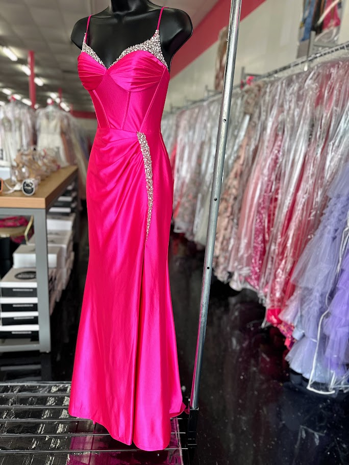 Expertly crafted with a flattering corset bodice and a sparkling crystal V-neckline, the Candice Wang 72345 Prom Dress exudes elegance and sophistication. Made from high-quality satin, this dress is both comfortable and luxurious. The figure-hugging design, with a sexy thigh-high slit, is perfect for any formal event.

Sizes: 0, 12

Colors: Hot Pink
