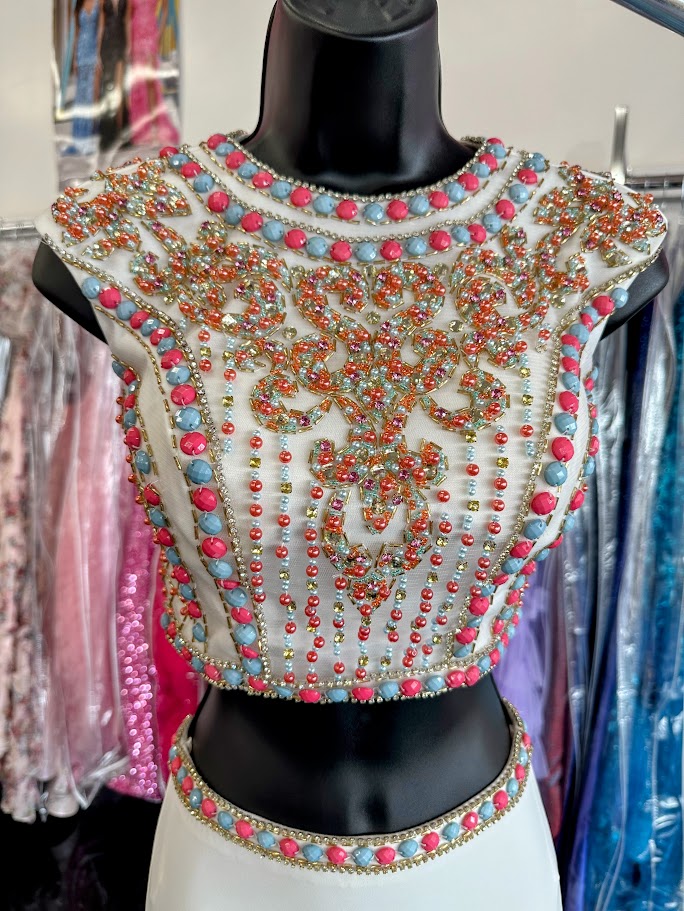 JVN by Jovani style JVN34015 Sexy two piece prom dress features sleeveless multicolored coral and mint beaded top with cutout back and a fitted jersey skirt.&nbsp;Two Piece Beaded Prom Dress High Neck Formal Gown JVN 34015

Available Size: 0

Available Color: White