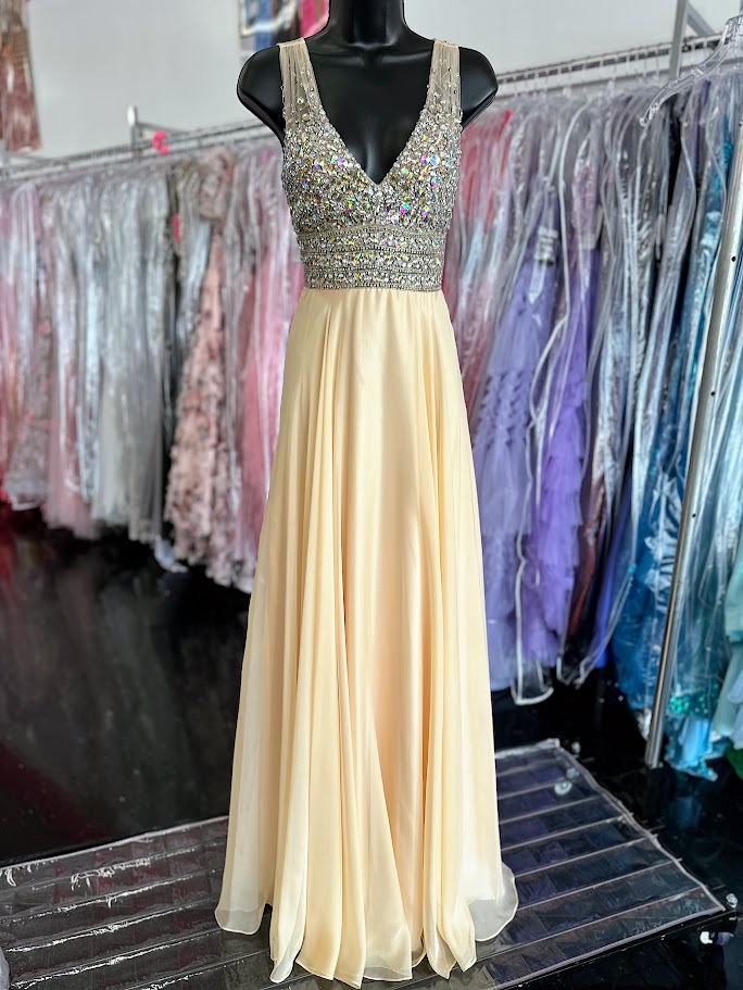 Jovani JVN20437 Stunning chiffon flowy prom dress features sheer v neck beaded top. Makes a beautiful pageant gown.&nbsp; In stock in light yellow size 0.

Style#: JVN20437
Fabric: Chiffon
Fit: A-Line
Length: Long
Neckline: V-Neckline
Waistline: Natural Waist



