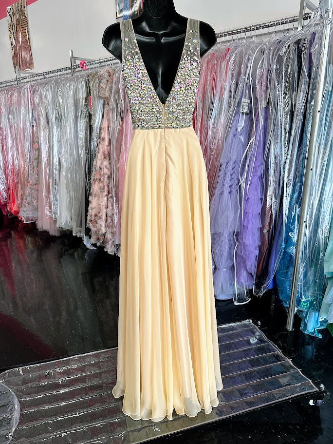 Jovani JVN20437 Stunning chiffon flowy prom dress features sheer v neck beaded top. Makes a beautiful pageant gown.&nbsp; In stock in light yellow size 0.

Style#: JVN20437
Fabric: Chiffon
Fit: A-Line
Length: Long
Neckline: V-Neckline
Waistline: Natural Waist



