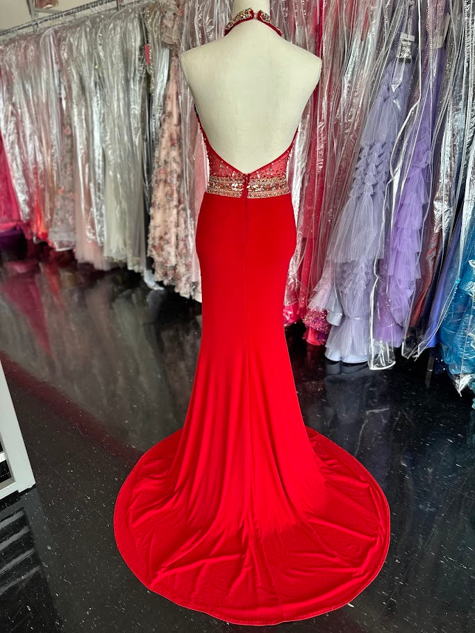 Make a striking entrance with the Jovani JVN23576, a size 2 red prom dress designed for confidence and elegance. This gown features a sheer long overlay paired with a chic choker neckline that frames the plunging neckline beautifully. A daring slit adds both allure and ease of movement, perfect for pageants or formal events. Crafted to enhance your silhouette, this dress balances bold design with refined sophistication.

Stunning halter form fitting dress features a sexy thigh high slit and crystal embellis