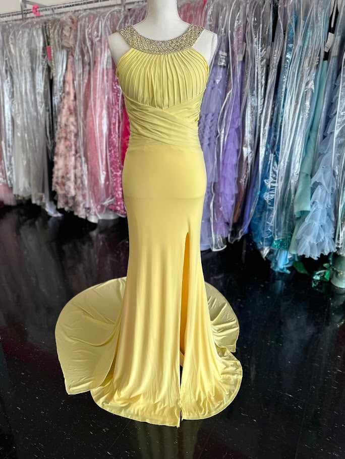 Jovani JVN93211 is a stunning Long Fitted Jersey Formal evening gown. Featuring a high Crystal Embellished Neckline and pleated bust with an asymmetrical bandage wrapped waist. This stunning Prom &amp; Pageant gown features a Slit in the skirt and sweeping train.

Available Size: 2

Available Color: Yellow