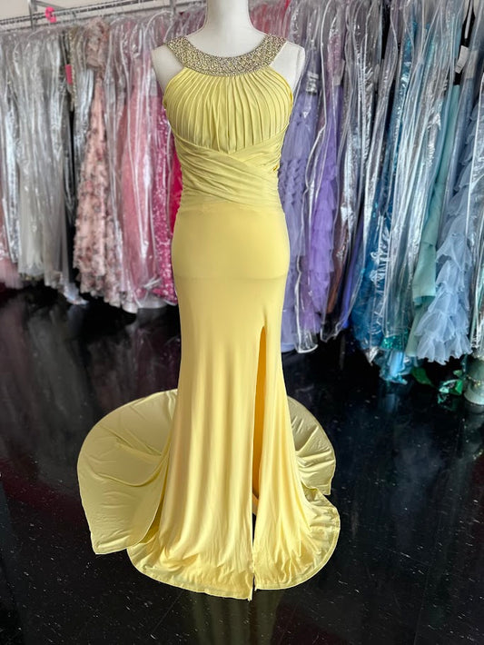 Jovani JVN93211 is a stunning Long Fitted Jersey Formal evening gown. Featuring a high Crystal Embellished Neckline and pleated bust with an asymmetrical bandage wrapped waist. This stunning Prom &amp; Pageant gown features a Slit in the skirt and sweeping train.

Available Size: 2

Available Color: Yellow