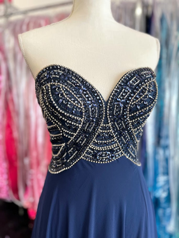 Envious Couture E1467 by Karishma Creations is a long Prom, Pageant &amp; Bridal Dress. Featuring a strapless sweetheart neckline with a Crystal embellished bodice and a flowing chiffon high waist skirt. Slit in the side skirt.

Size 8 Navy