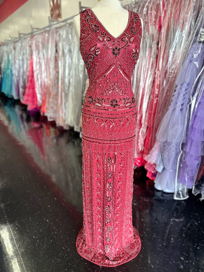 Zasa Chic K 2012 is a long Fitted formal Evening gown featuring Beading &amp; Embellishments. V Neckline with a backless cutout design. Slit in the back for a classic look &amp; Comfortable wear.

Available Size: 14

Available Color: Sorbet (Darker Mauve Color)