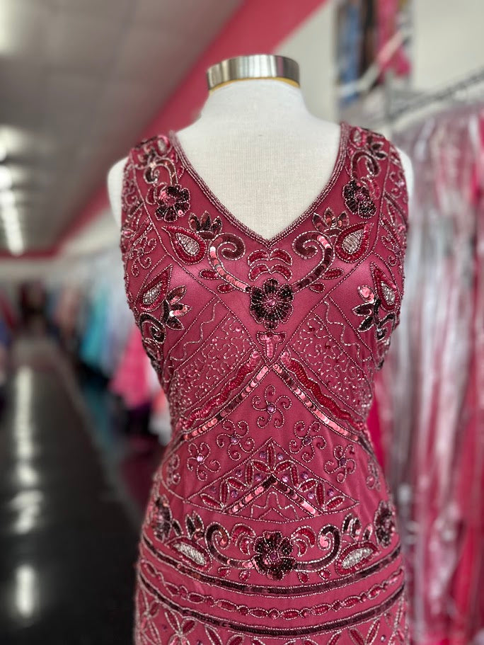 Zasa Chic K 2012 is a long Fitted formal Evening gown featuring Beading &amp; Embellishments. V Neckline with a backless cutout design. Slit in the back for a classic look &amp; Comfortable wear.

Available Size: 14

Available Color: Sorbet (Darker Mauve Color)