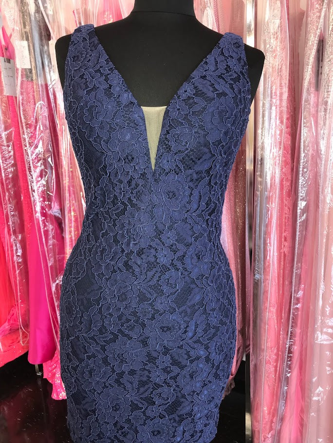 Nina Canacci 266 is a short fitted formal lace cocktail dress. Featuring a V neckline and sheer mesh side panel sides. This simple &amp; Elegant style is perfect for any formal or semi formal event! Open V back.

Sizes:&nbsp;2, 4, 6

Colors:&nbsp;Burgundy, Navy