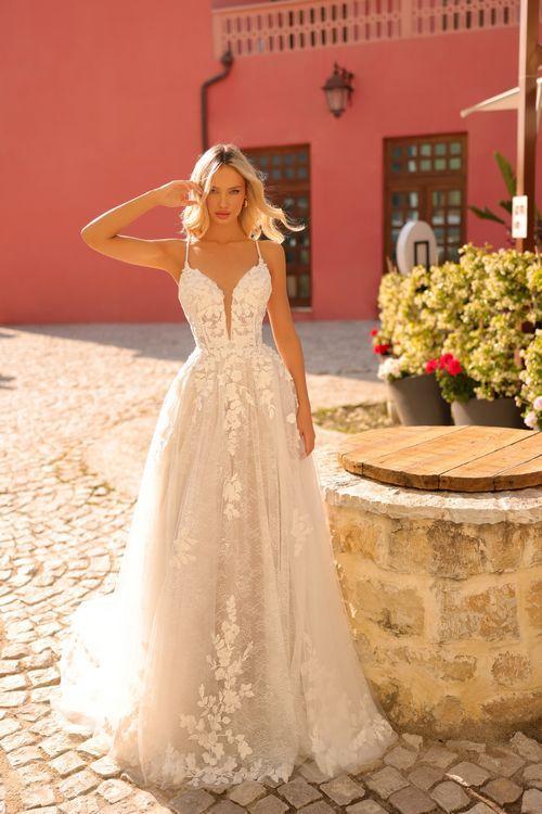 Amarra Bridal 84222 Scarlett Long Lace A Line Wedding Dress V Neck Drop Back Gown Scarlett is an ultra-elegant A-line wedding dress. This gown combines modern charm with timeless sophistication. Designed with comfort in mind, it is perfect for summer and warm days. The fabrics are soft and breathable and create a delightful sensation against your skin. Its flowy design allows for unrestricted movement, ensuring you feel light and airy.