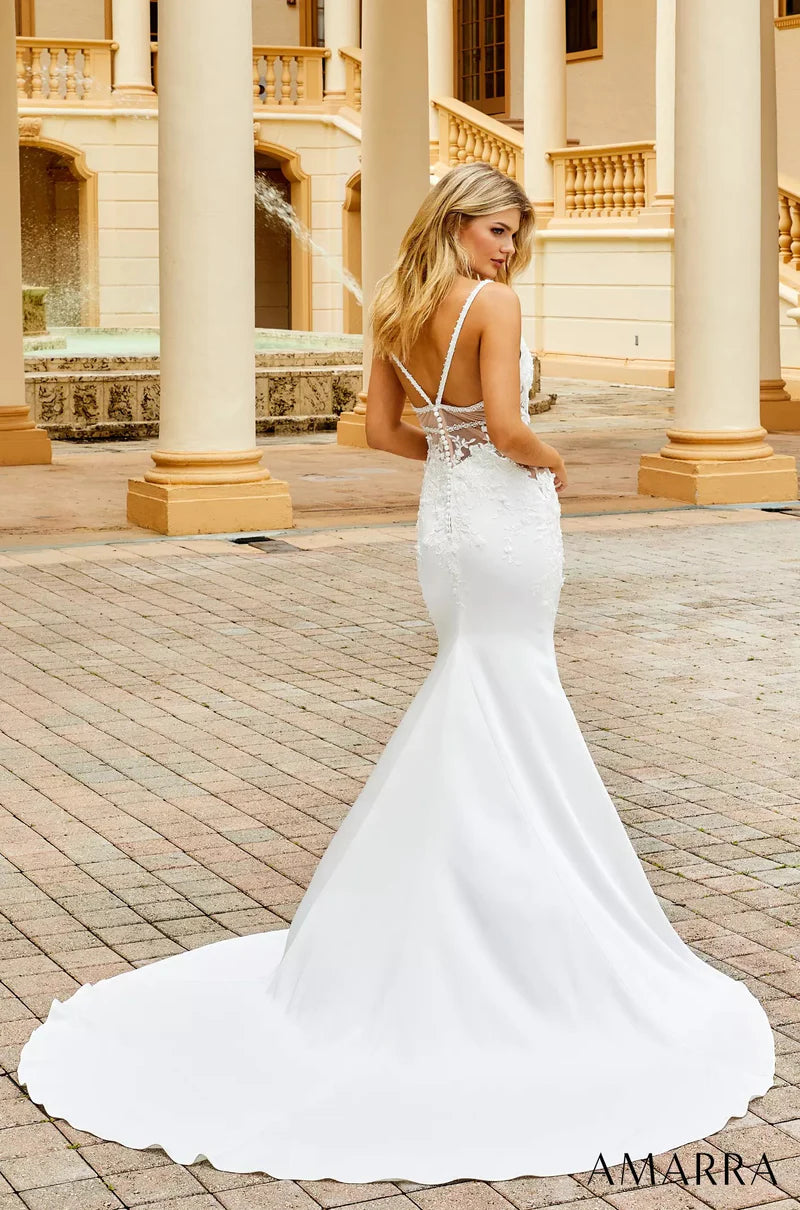 Amarra Bridal 7010 Isabella Mermaid Deep V-Neck Side Mesh Cutouts Train Wedding Gown. Feel like a queen in this luxurious lace wedding gown. Featuring lace sheer cutouts on each side and a fitted design, Isabella brings elegance and sophistication to your wedding look.