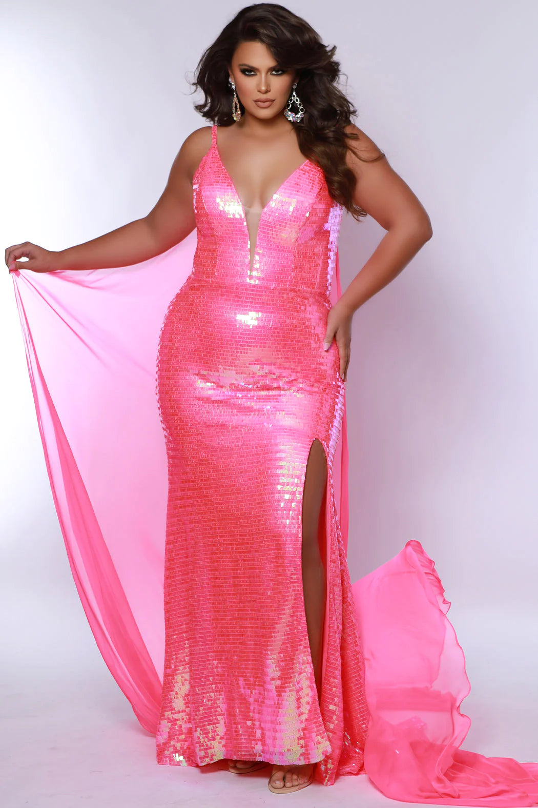 The Sydneys Closet JK2413 is a stunning long, fitted plus size prom dress with a sequin cape and a plunging neckline, V-back, and slit. The perfect dress for a special occasion, this gown is sure to make you stand out. Strut your stuff at any formal evening in this glamorous plus size sequin pageant gown. The Shocks floor-length evening dress dazzles in overall piano key fabric that sparkles all night.