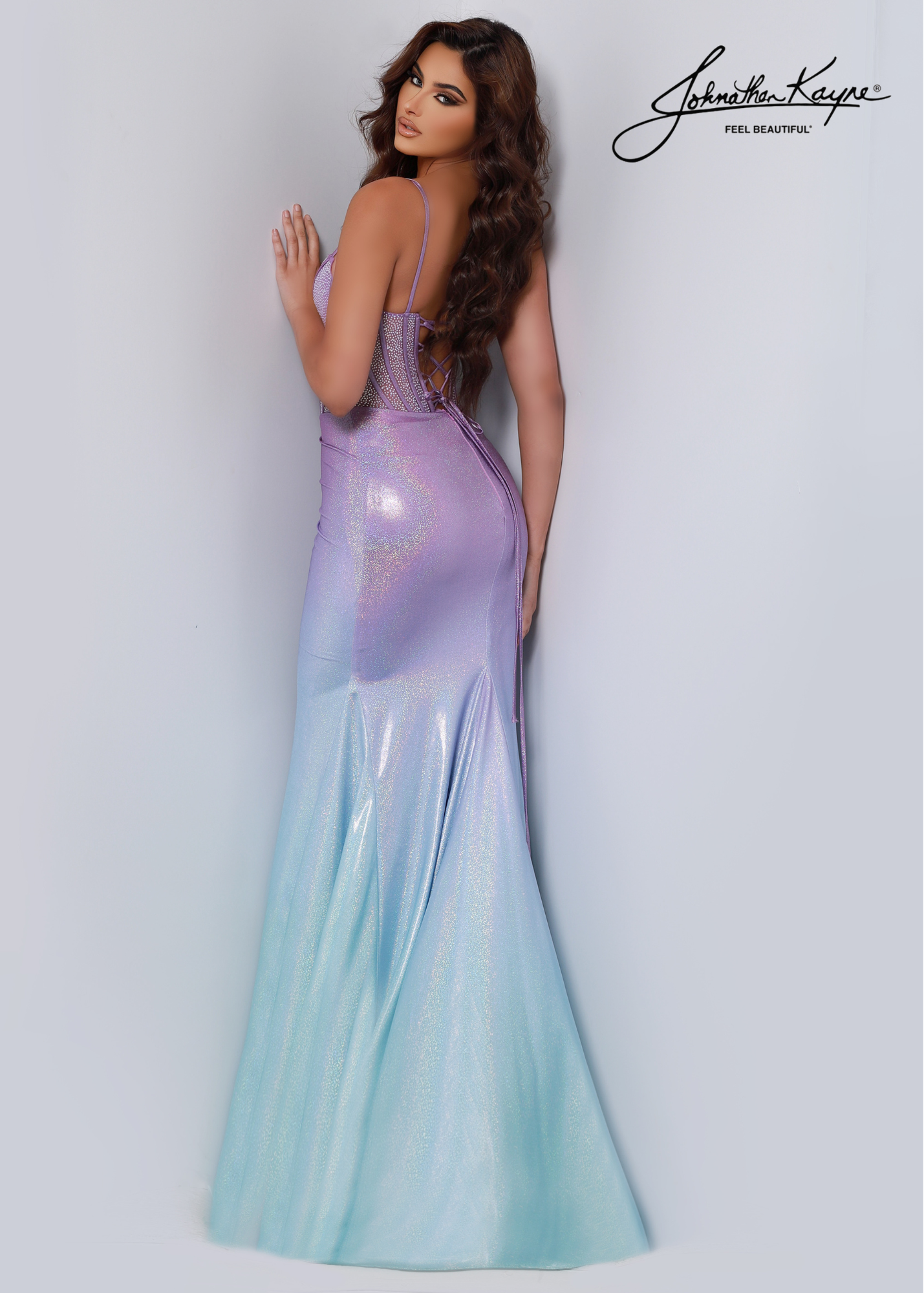 Johnathan Kayne 2648 is an elegant formal dress, featuring a strapless bodice, corset-style back, and a beautiful ombre hue. Its dramatic high slit and soft flowing skirt make it the perfect choice for any pageant or special occasion. Be a mermaid and make waves at your next special event with this ombre stretch jersey beauty! The semi-sheer bodice is finished with decorative boning and corset back to accentuate your waist.
