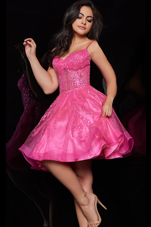 Jovani JVN25912 Pink Sheer Corset Bodice Sequins Embroidery Sweetheart Neckline Fit and Flare Short Homecoming Dress. JVN25912 Pink Corset Bodice Fit and Flare Homecoming Dress from the Cocktail and Homecoming collection is perfect for any formal occasion. The intricate sequins and embroidery details add a touch of elegance and sophistication, while the sweetheart neckline and spaghetti straps create a flirty and feminine silhouette.