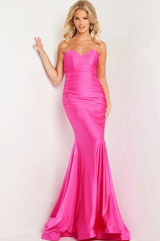 This stunning Jovani JVN37006 dress features a long ruched mermaid silhouette, perfect for any formal occasion. Made with high-quality jersey fabric, its strapless design exudes effortless elegance. Elevate your prom night or special event with this timeless and figure-flattering piece.  Sizes: 00-24  Colors: Black, Fuchsia