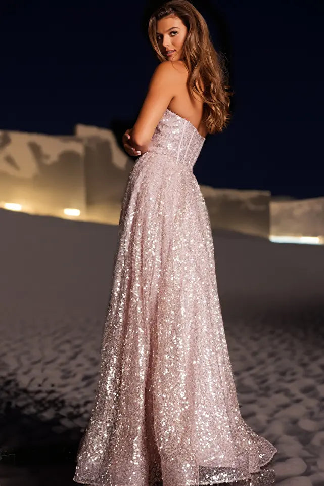 Get ready to sparkle in style with the JVN38607 prom dress! This strapless gown features a corset bodice and sweetheart neckline, creating a flattering A-line silhouette. The shimmering fabric adds a touch of glam, perfect for prom or any special occasion. Shine bright in this one-of-a-kind dress.