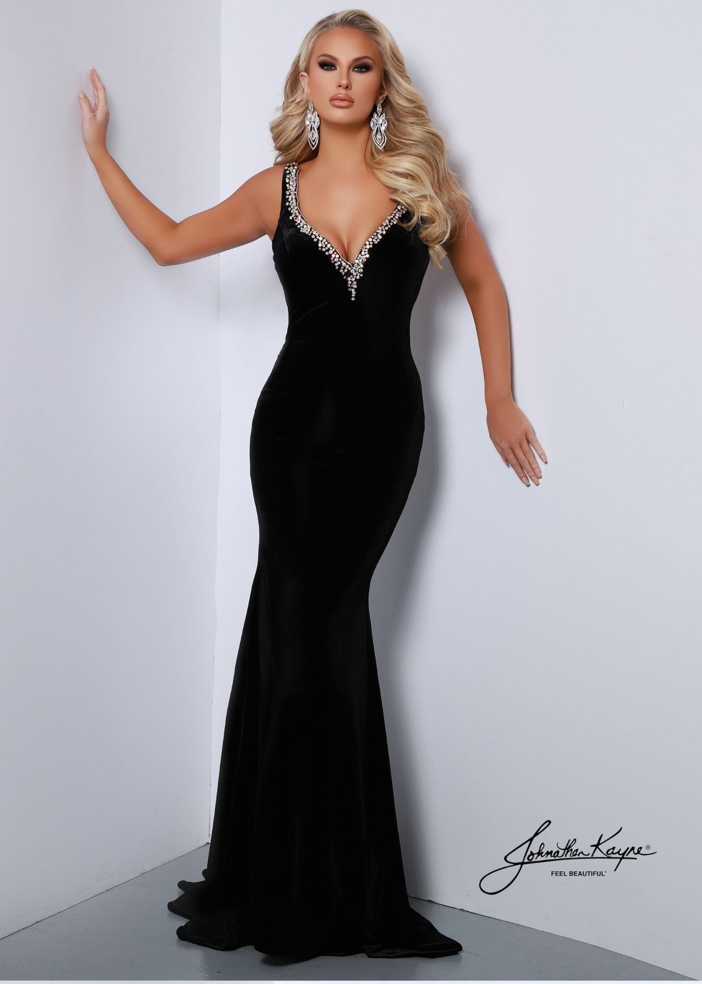Look perfect on your special day in the Johnathan Kayne 2534 sleek stretch velvet gown. The V neckline and low back are adorned in rhinestones, and a corset back ensures a perfect fit. You'll feel comfortable and stunning in this classic velvet dress.