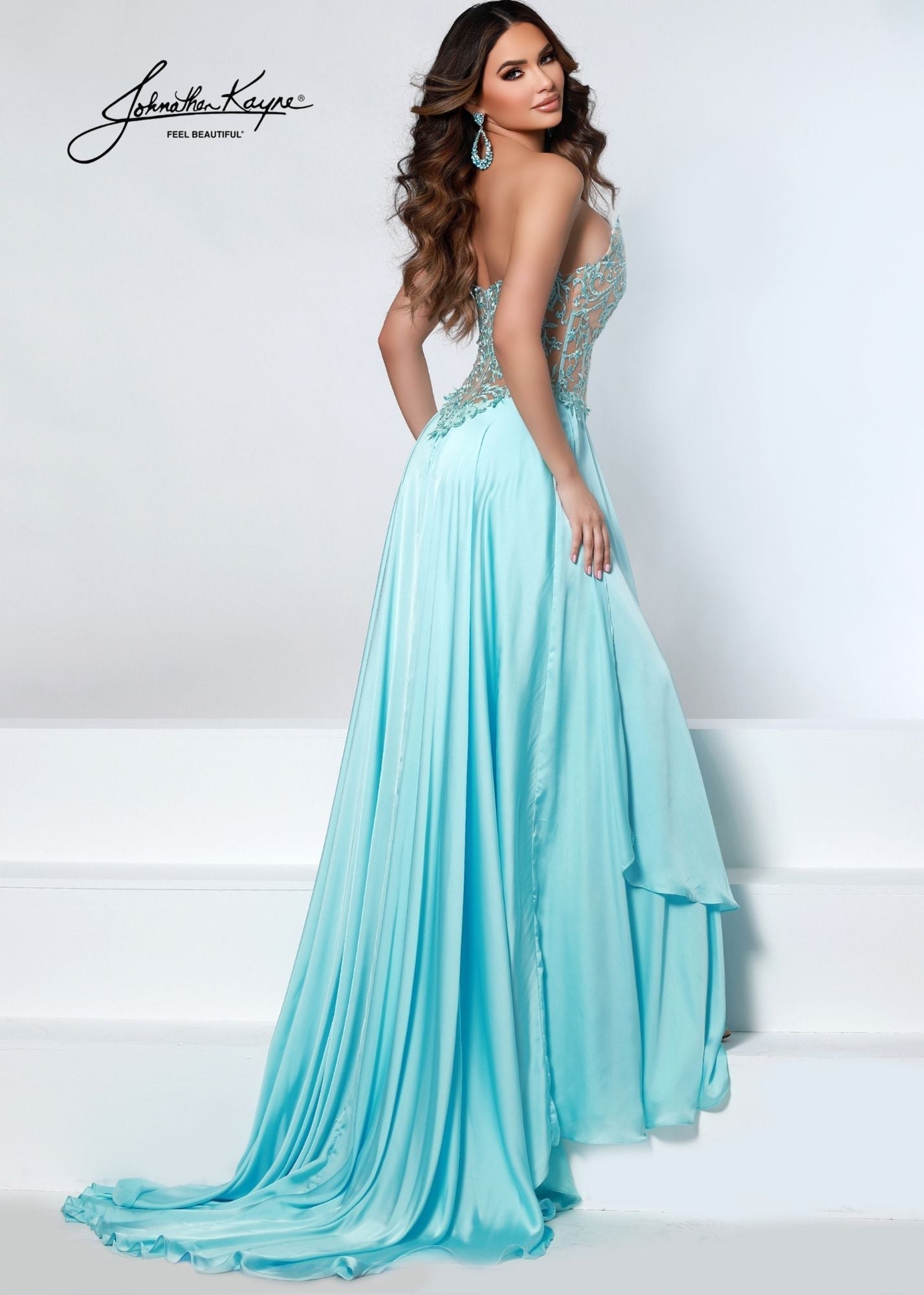 Johnathan Kayne Dress 2554 This pageant gown has a sheer embellished lace bodice with an asymmetrical waistline and peaks for the v neckline. The long charmeuse skirt is layered and has a very long train.  It has detachable off the shoulder straps if you wish.  Prom, Pageant and Evening Dresses  