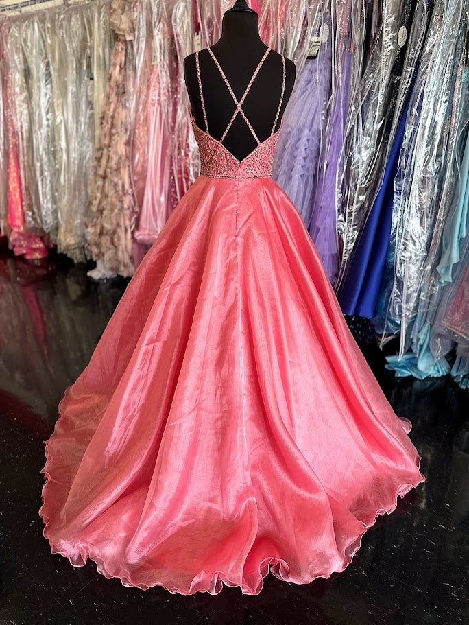 Elevate your prom night with the Johnathan Kayne 7219 long ballgown in a stunning coral hue. This size 4 dress features a graceful A-line silhouette complemented by a crystal-embellished V-neck, adding refined sparkle. Practical side pockets blend seamlessly into the design, offering convenience without sacrificing elegance. Perfect for making a memorable entrance with timeless sophistication.

Size: 4

Color: Coral