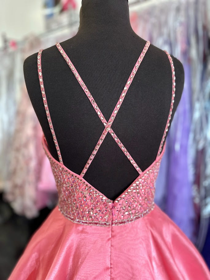 Elevate your prom night with the Johnathan Kayne 7219 long ballgown in a stunning coral hue. This size 4 dress features a graceful A-line silhouette complemented by a crystal-embellished V-neck, adding refined sparkle. Practical side pockets blend seamlessly into the design, offering convenience without sacrificing elegance. Perfect for making a memorable entrance with timeless sophistication.

Size: 4

Color: Coral