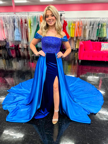 This Johnathan Kayne 2725 gown combines luxurious velvet with elegant satin details for a striking pageant look. The fitted silhouette features a straight neckline and a crystal-beaded bodice that adds refined sparkle. Detachable off-the-shoulder satin sleeves offer versatile styling, while the long satin overskirt and corset lace-up back with crystal tassels enhance both drama and fit. A tasteful slit completes this sophisticated design, perfect for making a memorable impression.

Size: 4&nbsp;

Color: Roy