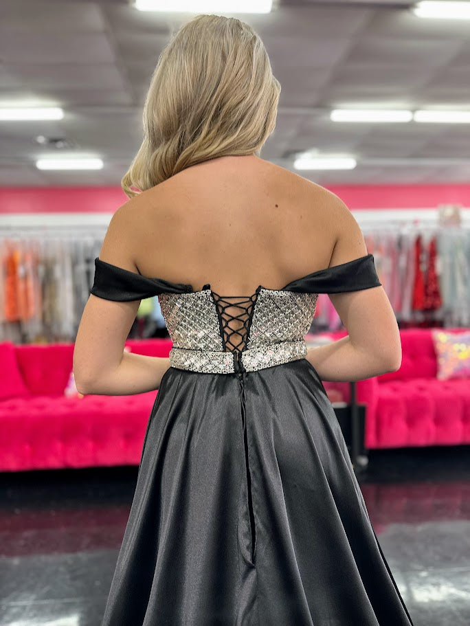 This Johnathan Kayne 2725 gown combines luxurious velvet with elegant satin details for a striking pageant look. The fitted silhouette features a straight neckline and a crystal-beaded bodice that adds refined sparkle. Detachable off-the-shoulder satin sleeves offer versatile styling, while the long satin overskirt and corset lace-up back with crystal tassels enhance both drama and fit. A tasteful slit completes this sophisticated design, perfect for making a memorable impression.

Size: 4&nbsp;

Color: Bla