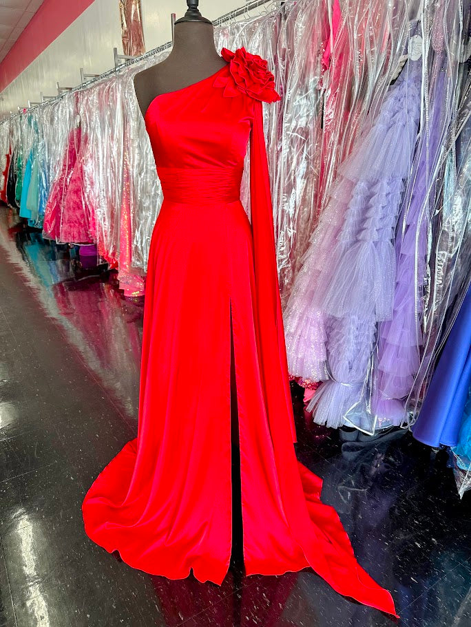 Elevate your formal occasion with this Johnathan Kayne gown, featuring a striking one-shoulder design and a flowing satin cape. The vibrant red fabric drapes elegantly, complemented by a tasteful slit and delicate floral accents. Tailored in size 4, this long dress combines classic sophistication with modern flair, perfect for pageants or special appearances.

Size: 4

Color: Red