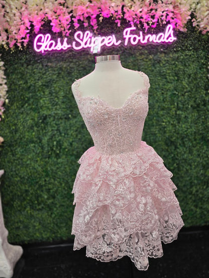 Upgrade your homecoming style with the Jovani 37080 Short Lace Ruffle Dress. The sequin embellished lace corset and asymmetrical layered short skirt create a chic silhouette, perfect for a night out. Stand out in this elegant and trendy cocktail dress. This Cocktail Dress is perfect for any formal occasion!