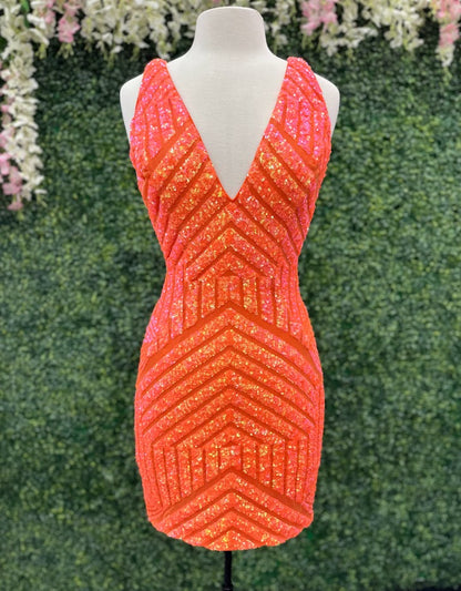 Jovani 63899 is a short fitted Homecoming cocktail dress, Sequin Embellished with a deep plunging V Neckline and open scoop back. Sheer mesh side panels. Stretch sequin for a comfortable wear all night long. Great for Prom, Pageants, Homecoming & any Formal Event! The shimmering dress features a flattering v-neckline, straps, and a fitted silhouette that will accentuate your curves.