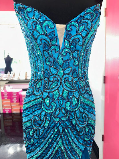 The Jovani 38707 prom dress is a stunning and sophisticated gown designed for formal occasions, making it a perfect choice for prom. This floor-length dress is made from delicate mesh fabric, which gives it a lightweight and semi-transparent quality, adding a touch of elegance to the overall look.