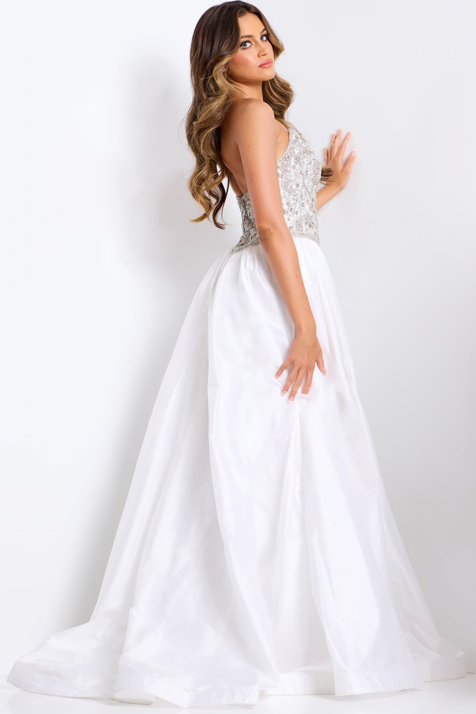 Elevate your pageant or prom look with the Jovani 49247, a stunning beaded ballgown designed to turn heads. This A-line silhouette features a crystal-embellished V-neck bodice with strapless construction for a sophisticated, glamorous appearance. The maxi length with dramatic slit provides elegant movement and floor-sweeping drama. Perfect for pageants, proms, and formal events where you want to make an unforgettable impression.

Sizes: 00-14

Colors: Fuchsia, Royal, White, Silver