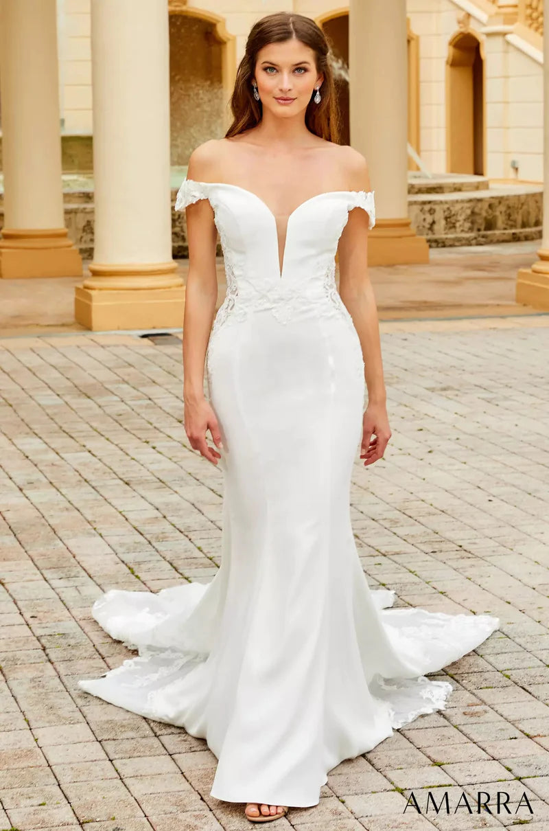 Amarra Bridal 7034 Julie Fitted Off The Shoulder Lace Up Back Plunging Neckline Floral Lace Cut-Outs Train Wedding Gown. For the glamorous and alluring bride, Julie delivers. This trumpet-style wedding dress featuring an off-the-shoulder look and lace cutouts at the side is sure to captivate