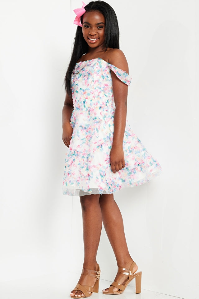 Jovani Kids K26293 Off The Shoulder Fit And Flare Floral Short Girls Dress. This Jovani dress is for the little girl who loves to twirl! Featuring an off the shoulder fit and flare silhouette, this floral beauty will have your little one feeling like a true princess. She’ll never want to take it off! (But you probably will need her to!)