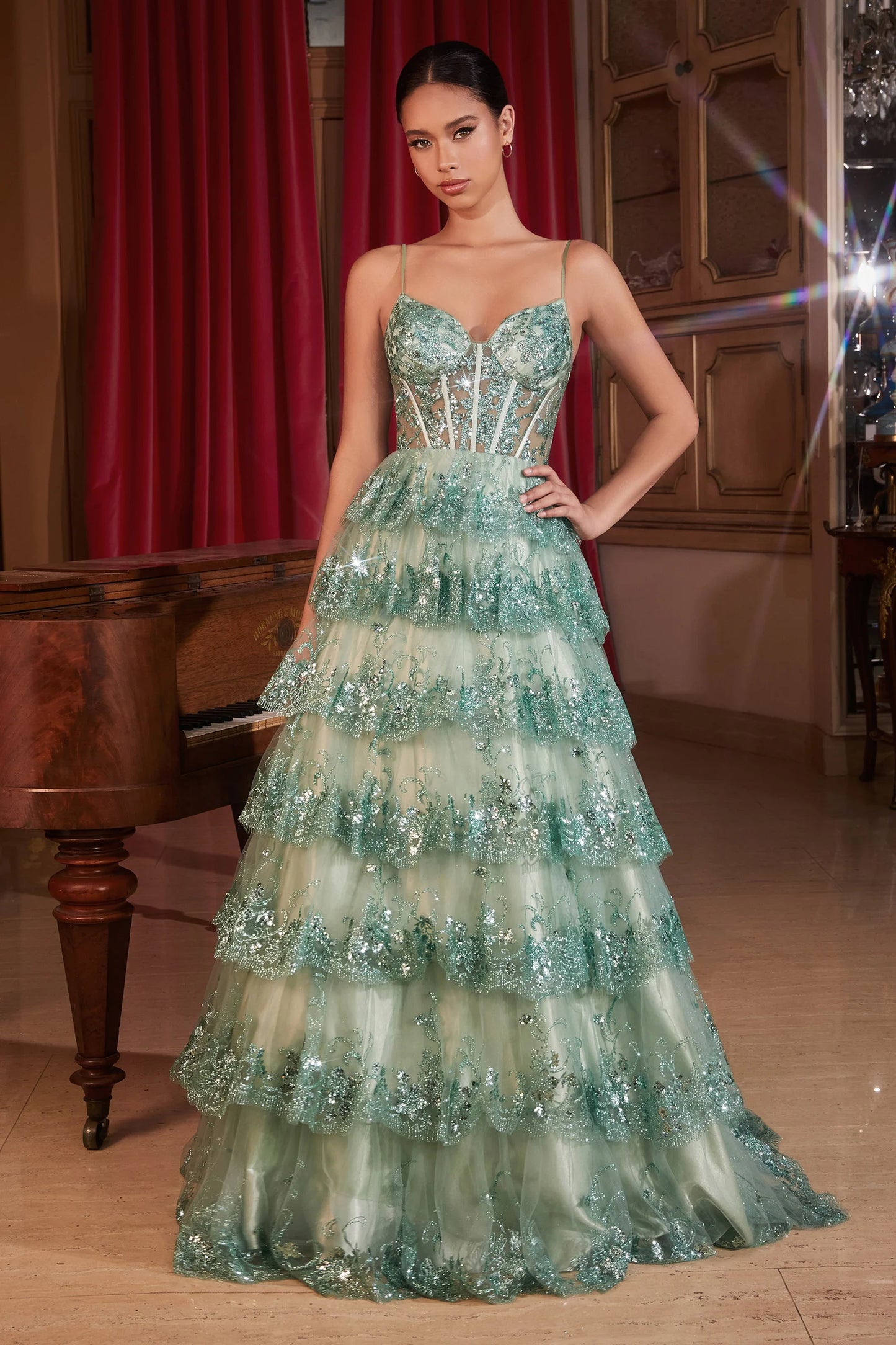This Ladivine KV1108 Prom Dress features a sheer sequin corset, A-line cut, and ruffle detailing, creating a stunning and elegant silhouette. The layered tulle skirt adds volume and drama, making it the perfect option for formal events and balls. Step into enchantment with this sultry A-line ball gown—a bewitching fusion of glamour and allure. The layered tiered scalloped sequin ruffled skirt creates a mesmerizing play of light, ensuring every step is a symphony of elegance. 