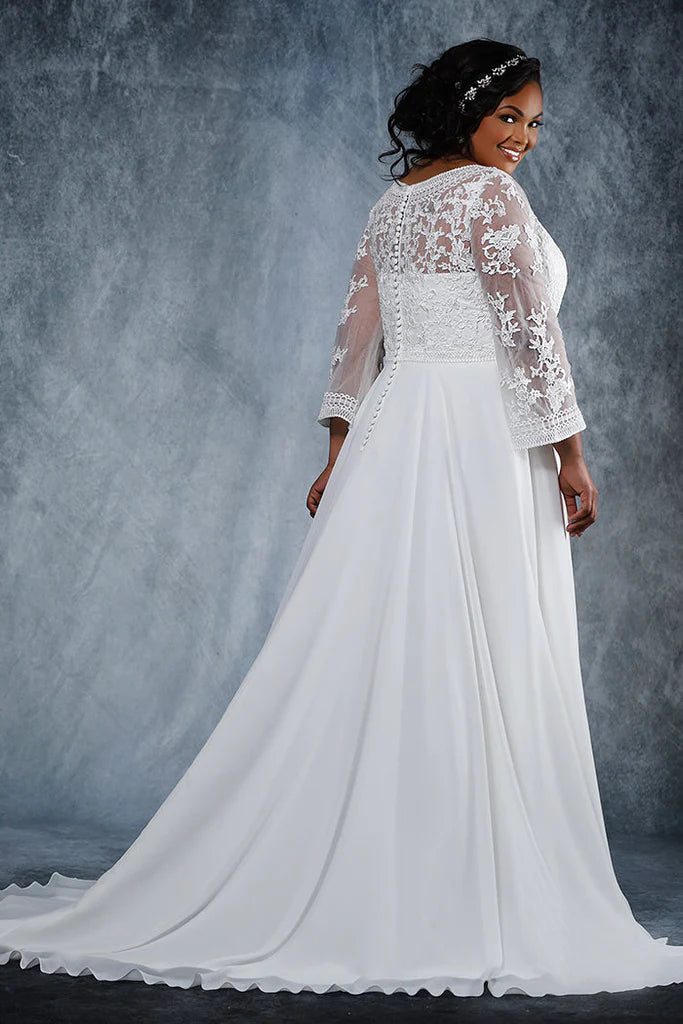 Michelle Bridal For Sydney's Closet MB2020 A-Line Deep V-Bodice With Illusion Mesh Insert Pleated chiffon skirt Chapel Train Unique Embroidered Design On Bodice And Lace Appliques On Illusion Sleeves Plus Size "Corrine" Bridal Gown. Fall in love with the unique look of the Michelle Bridal For Sydney's Closet MB2020 A-Line bridal gown. This plus size design features a deep V-bodice with illusion mesh insert, pleated chiffon skirt, and chapel train. 