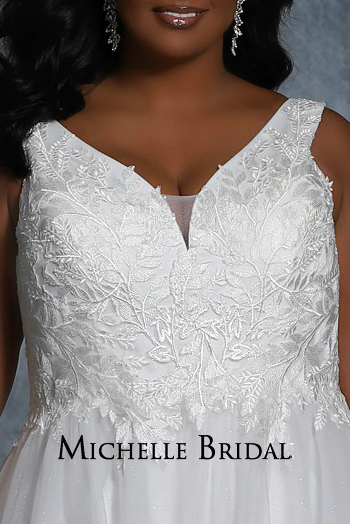 The Michelle Bridal For Sydney's Closet MB2109 Bridal Gown is a beautiful A-Line silhouette with layered tulle and sparkle tulle appliques, contemporary floral bridal lace, and a flattering V-Neck. Designed for plus size brides, this gown will make you feel like a true "Jewel" on your special day.