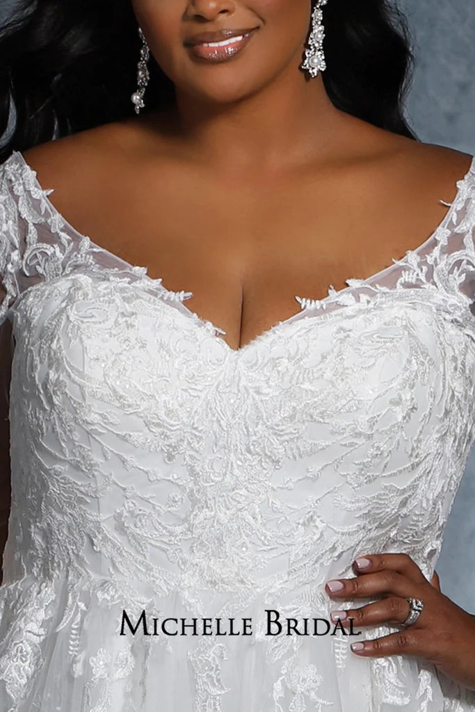 Experience elegance and luxury with this beautiful Michelle Bridal for Sydney's Closet MB2118 gown. It features a v-neck silhouette with long sleeves, embroidered lace appliques, and sequins for a truly unique look. Plus size and "Madonna" styles also available.