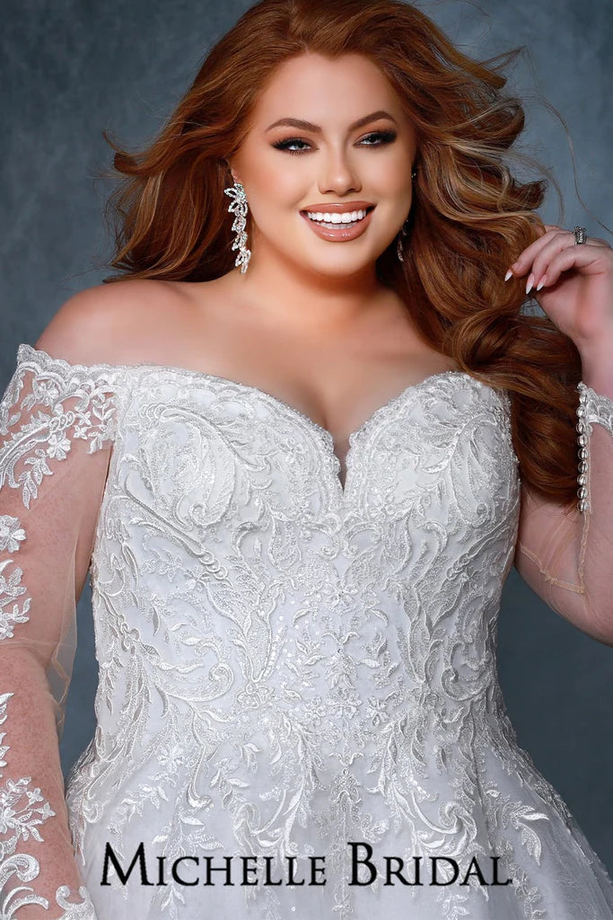 Michelle Bridal For Sydney's Closet MB2210 A-Line Silhouette Beaded Scalloped Neckline And Sleeve Clear Bugle Beads Back Basque Waist Long Sleeves Off The Shoulder Plus Size "Madeline" Bridal Gown. The Michelle Bridal For Sydney's Closet MB2210 bridal gown is an exquisite piece of craftsmanship. Featuring an A-line silhouette, a scalloped neckline and sleeve, clear bugle beads, a back basque waist, and off-the-shoulder long sleeves