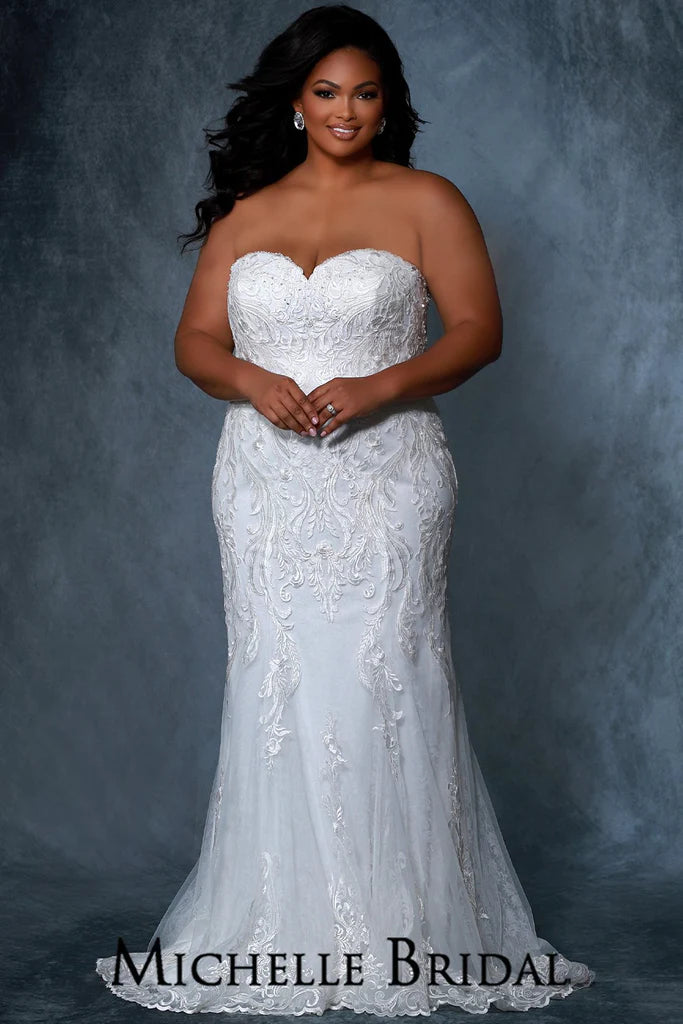 Michelle Bridal For Sydney's Closet MB2216 Fitted Slim Silhouette Sweetheart Neckline Scalloped Hem With Clear Sequins Embroidered Lace Appliques On Soft Bridal Tulle Chantilly Lace Plus Size "Amelia" Bridal Gown. Michelle Bridal for Sydney's Closet MB2216 dress is the perfect choice for any special occasion. This fitted slim silhouette features a sweetheart neckline, scalloped hem, and clear sequin embroidered lace appliques. Crafted from soft bridal tulle and Chantilly lace