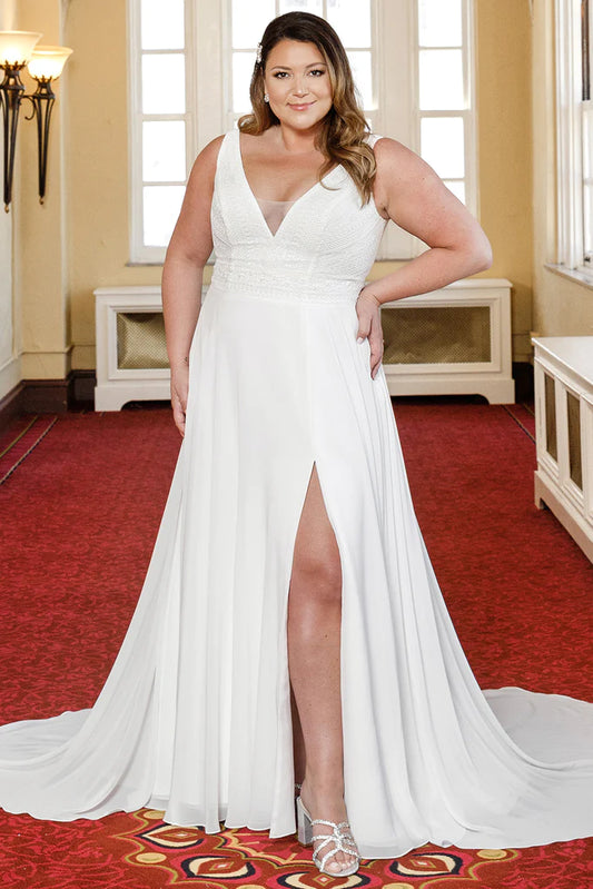 Michelle Bridal For Sydney's Closet MB2304 A-Line Bridal Chiffon Boho Lace Sleeveless V-Neck Plus Size "Taye" Bridal Dress. Look stunning on your special day in this Michelle Bridal For Sydney's Closet MB2304 A-Line dress. Features include an elegant chiffon bodice, delicate boho lace accents, sleeveless v-neck, and a beautiful A-line skirt. Perfect for the full-figured bride!