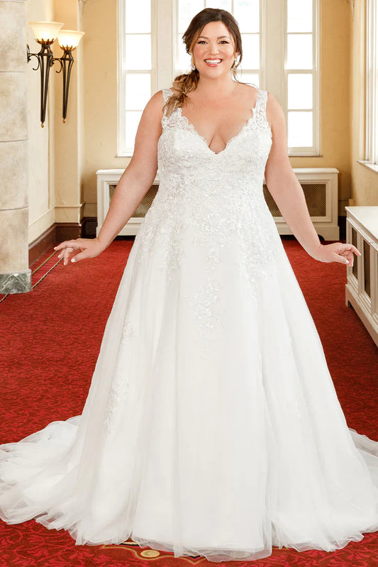 Michelle Bridal For Sydney's Closet MB2307 A-Line Soft Bridal Tulle Floral Appliques Clear Sequins V-Neck Sleeveless Plus Size "Hermione" Bridal Gown. The Michelle Bridal For Sydney's Closet MB2307 bridal gown is a stunning plus size ensemble. Crafted with soft bridal tulle and intricate floral appliques, the A-line silhouette features elegant clear sequins detailing along a flattering V-neckline and sleeveless cut. Perfect for a regal yet romantic bridal look, it is sure to make any wedding day memorable.