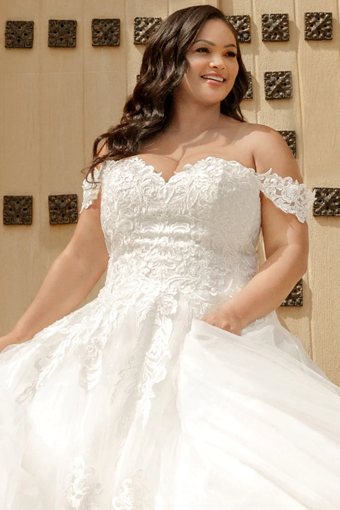 Michelle Bridal For Sydney's Closet MB2310 Soft Bridal Tulle Over Embossed Tulle Floral Pattern Embroidered Lace Appliques Clear Sequins Off The Shoulder Lace Straps  Plus Size "Denali" Bridal Gown. Featuring beautiful lace appliques, clear sequins, and off-the-shoulder straps, the Michelle Bridal For Sydney's Closet MB2310 plus-size wedding dress makes an eye-catching statement. Crafted from embroidered tulle and soft bridal tulle over embossed tulle,