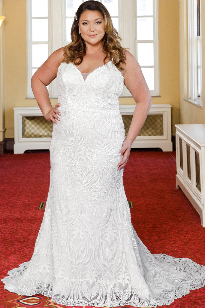 Michelle Bridal For Sydney's Closet MB2314 Slim Silhouette Crochet Lace Bridal Tulle V-Neck Optional Modesty Panelt Plus Size "Maya" Bridal Gown. The Michelle Bridal for Sydney's Closet MB2314 gown is the perfect choice for the modern bride. This slim silhouette gown is crafted with intricate crochet lace and soft tulle, and features an optional modesty panel for added coverage. The V-neckline flatters the figure, while the plus size construction ensures a perfect fit. This dress exudes luxury