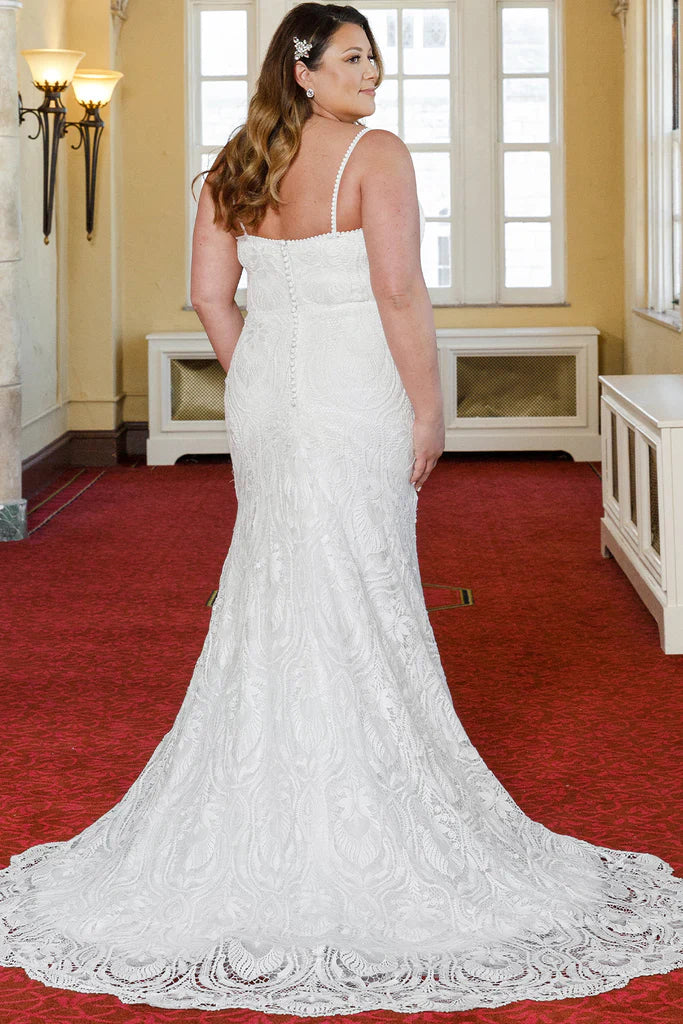Michelle Bridal For Sydney's Closet MB2314 Slim Silhouette Crochet Lace Bridal Tulle V-Neck Optional Modesty Panelt Plus Size "Maya" Bridal Gown. The Michelle Bridal for Sydney's Closet MB2314 gown is the perfect choice for the modern bride. This slim silhouette gown is crafted with intricate crochet lace and soft tulle, and features an optional modesty panel for added coverage. The V-neckline flatters the figure, while the plus size construction ensures a perfect fit. This dress exudes luxury,