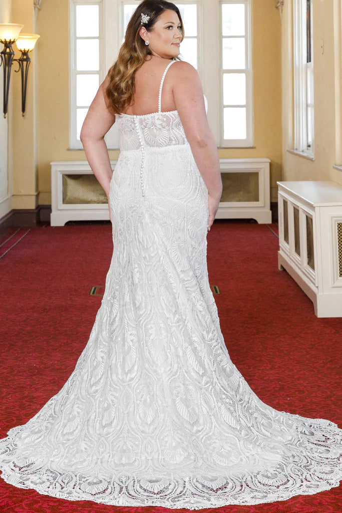 Michelle Bridal For Sydney's Closet MB2314 Slim Silhouette Crochet Lace Bridal Tulle V-Neck Optional Modesty Panelt Plus Size "Maya" Bridal Gown. The Michelle Bridal for Sydney's Closet MB2314 gown is the perfect choice for the modern bride. This slim silhouette gown is crafted with intricate crochet lace and soft tulle, and features an optional modesty panel for added coverage. The V-neckline flatters the figure, while the plus size construction ensures a perfect fit. This dress exudes luxury,