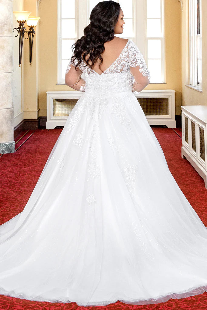 Michelle Bridal For Sydney's Closet MB2316 A-Line Embroidered Floral Appliques Clear Sequins Bugle Beads Petal Beads Bridal Tulle Floral Lace Long Sleeves Covered Buttons V-Neck Plus Size "Cleo" Bridal Gown. Michelle Bridal for Sydney's Closet MB2316 features an elegant a-line silhouette with stunning embroidered floral appliques, clear sequins, bugle beads, and petal beads. Crafted with luxurious bridal tulle and floral lace, the gown has long sleeves and covered buttons at the V-neckline.