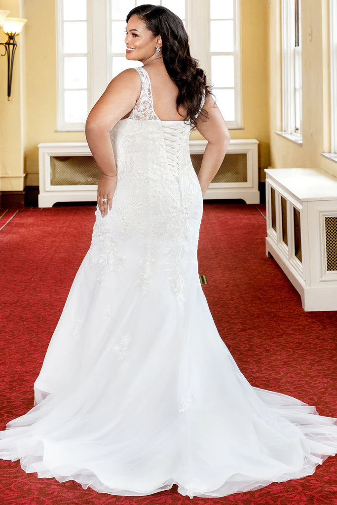 Michelle Bridal For Sydney's Closet MB2317 Fitted Silhouette Tulle Lace Embroidered Lace Appliques Seed Pearls Bugle Beads, Crystals Clear Sequins Satin Lining Deep V-Neck Plus Size "Netali" Bridal Gown. The "Netali" bridal gown from Michelle Bridal for Sydney's Closet MB2317 is designed to flatter any figure. It features a fitted silhouette made of tulle lace with embroidered lace appliques, seed pearls, bugle beads, and crystals clear sequins. The satin lining provides a comfortable fit