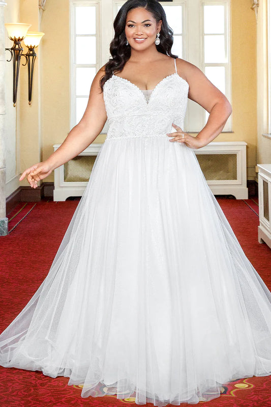 Michelle Bridal For Sydney's Closet MB2318 A-Line Lace Clear Sequins Soft Bridal Tulle Glitter Tulle Lace Trim Satin Plus Size "Coralie" Bridal Gown. The Michelle Bridal For Sydney's Closet MB2318 gown is perfect for the modern plus-size bride seeking a classic look. The A-Line silhouette features a glitter tulle skirt and sheer lace bodice, adorned with soft bridal tulle, clear sequins, and satin trim. Capture timeless elegance in the “Coralie” gown.