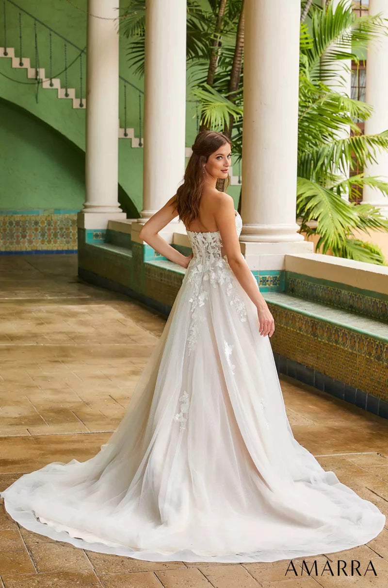 Amarra Bridal 84389 Madison A-Line Ballgown Sweetheart Neckline Strapless Floral Tulle Train Wedding Gown. This truly romantic wedding gown is perfect for the classic bride who wants to keep things traditional, but add her own elegant twist. Madison does just that, featuring a delicate V-neckline and floral lace appliques throughout the bodice, cascading down to a wide, billowy skirt. 