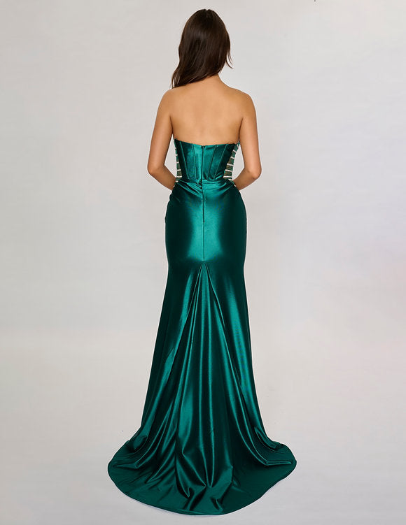 Make a bold entrance with the Nina Canacci 5307 gown. This long, fitted strapless dress features a seductive corset silhouette with sheer panels that hint at allure, while the satin fabric drapes smoothly across your figure. A daring thigh-high slit adds movement and confidence, perfect for unforgettable evenings and prom night glamour.

Size: 0-12

Color: Burgundy, Navy, Emerald