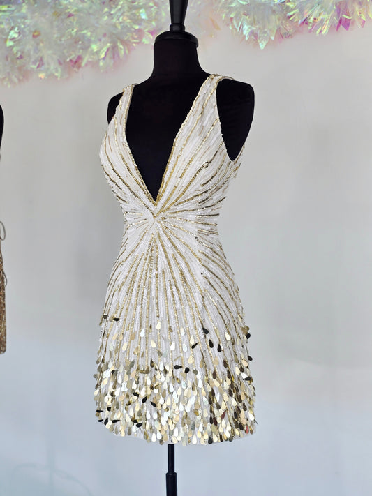 Step into the spotlight with the Primavera Couture 4417, a short backless cocktail gown designed to dazzle. Featuring a flattering V-neck and shimmering sequins, this homecoming dress combines elegance with a playful edge. Its backless design adds a touch of allure, perfect for making unforgettable memories at your special event. Comfortable and stylish, it’s crafted to help you feel confident and radiant all night long.

Sizes: 6

Colors: Ivory/Gold